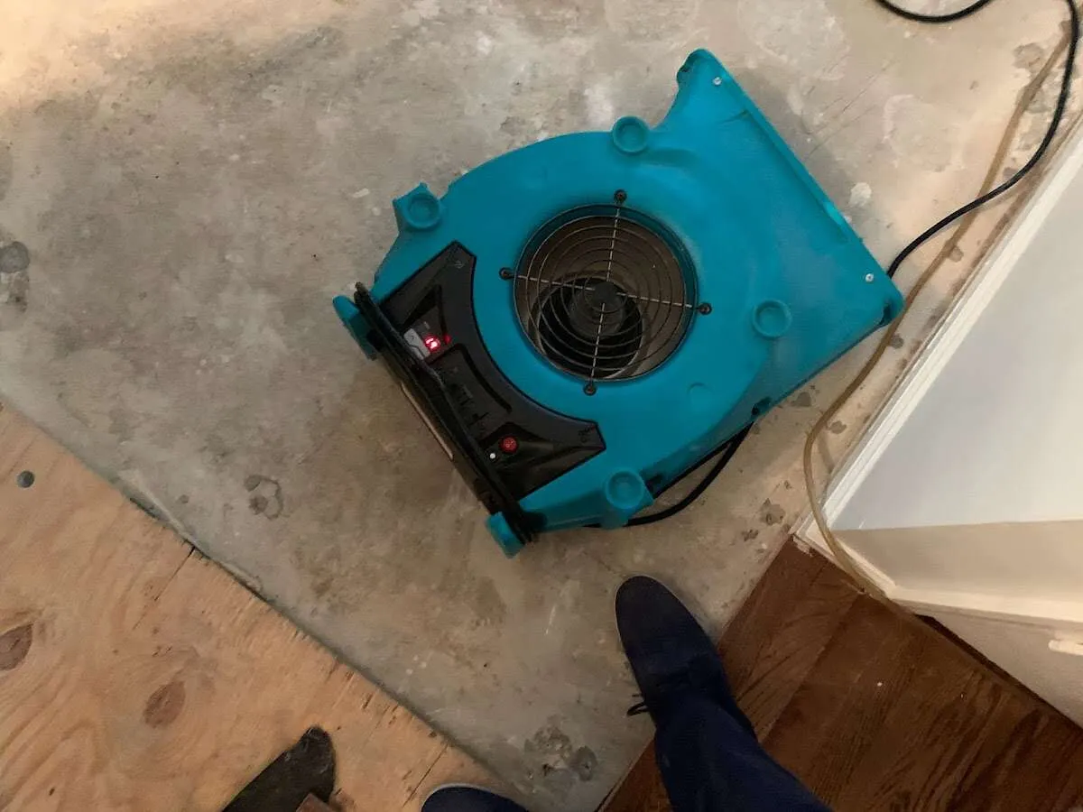 Air mover drying subfloor during Commercial Water Damage Restoration in Lincolnton